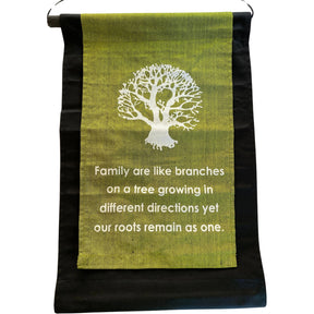 Green banner with a white tree and the quote "Family are like branches on a tree growing in different directions yet our roots remain as one."