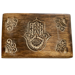 Wooden box with carved Hamsa hand and floral motifs.
