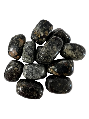 dark mottled stones with wisps of brown and white 
