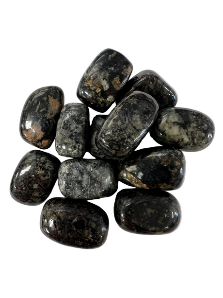 dark mottled stones with wisps of brown and white 
