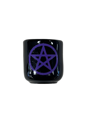 black cube shaped candle holder that is black wit a purple pentacle on it 
