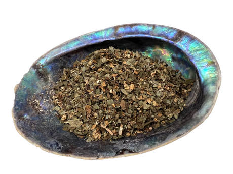 Abalone shell holding the cut up flowers and leaf 