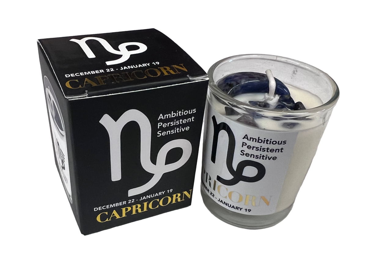 Capricorn candle and black packaging on a light white  background