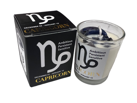 Capricorn candle and black packaging on a light white  background