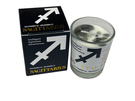 Sagittarius candle in a glass holder with packaging on a light gray background