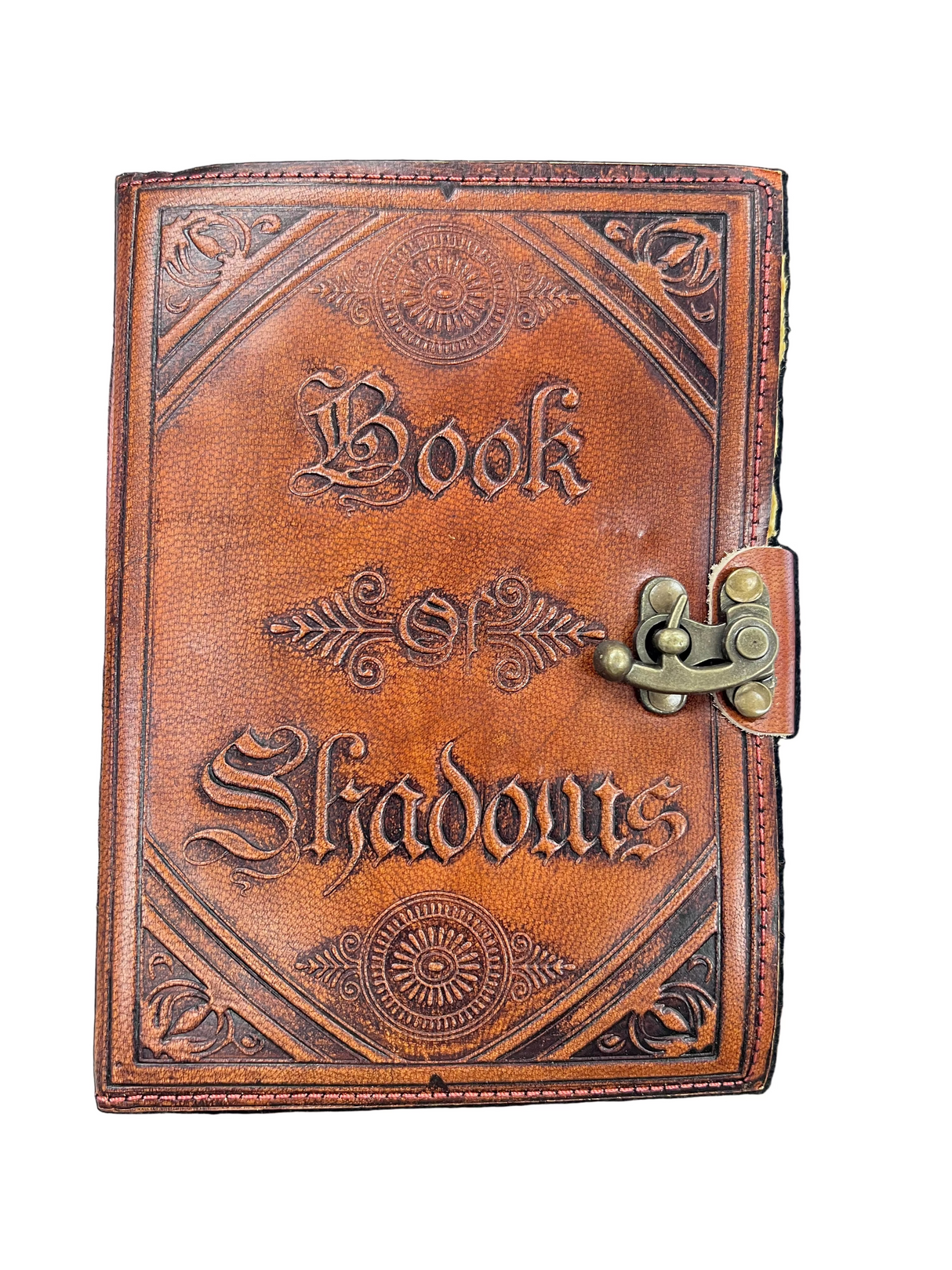 Leather-bound book titled 'Book of Shadows' with embossed text and a latch on a white background.