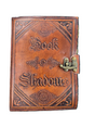 Leather-bound book titled 'Book of Shadows' with embossed text and a latch on a white background.