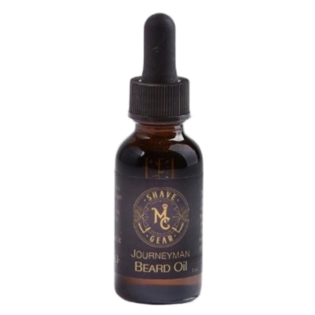 Amber glass bottle with a black dropper cap. The label reads "Shave Gear" and "Journeyman Beard Oil."