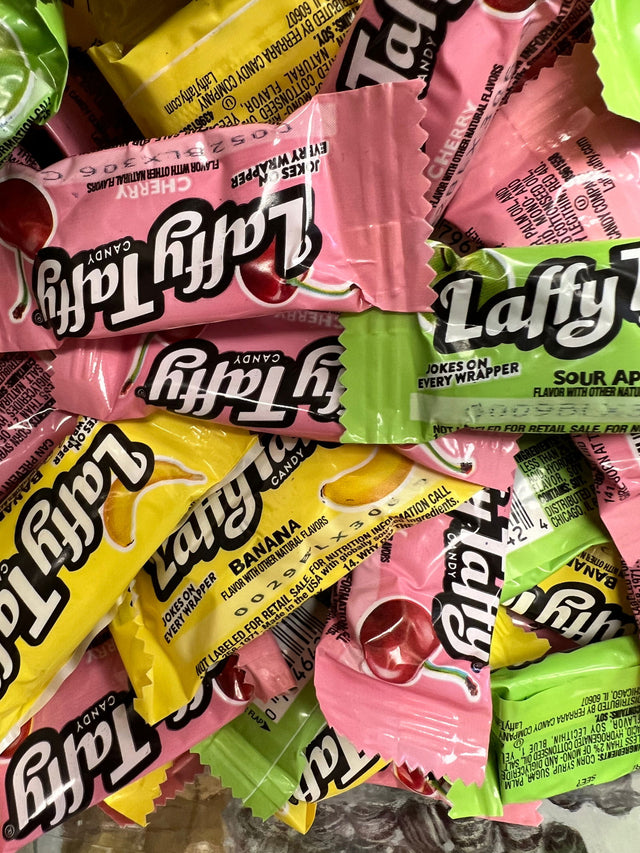 Laffy Taffy - multi colored inch long package with taffy taffy written on side 