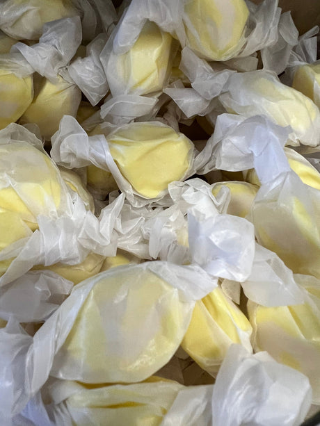 Lemon Salt Water Taffy - Yellow candy piece wrapped in wax paper 