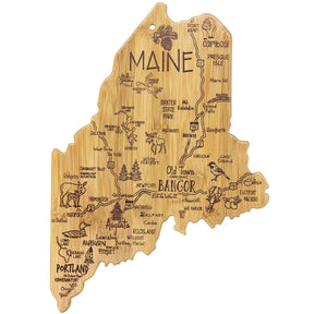 Bamboo cutting board with an engraved map of Maine, featuring cities, towns, landmarks, and illustrations.