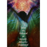 Greeting card with a woman standing in front of a colorful background with a flower of life symbol above her. The text "WHEN SHE BELIEVED IN HERSELF, MIRACLES HAPPENED" is written on the image.