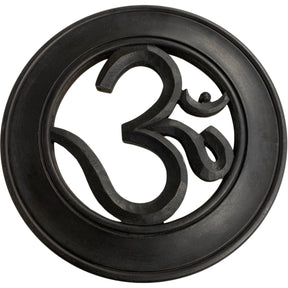 Circular wooden wall hanging with a carved OM symbol in the center.