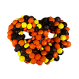 Reese's Pieces Pretzel Milk Chocolate - Palm size pretzel covered in orange yellow a nd black reeces pieces 