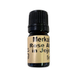 Rose Absolute in Jojoba Oil - Rose Absolute in Jojoba Oil - small amber colored bottle with light brown label and black screw cap.