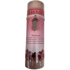 Red candle with "SERENITY" label and crystal pendant.