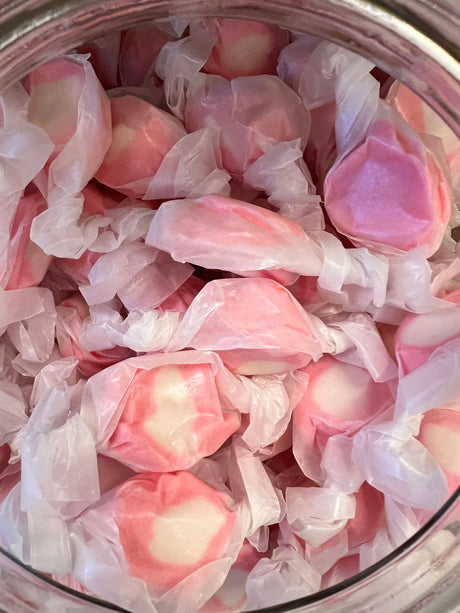 Strawberry Salt Water Taffy - Red candy with white swirl wrapped in wax paper 