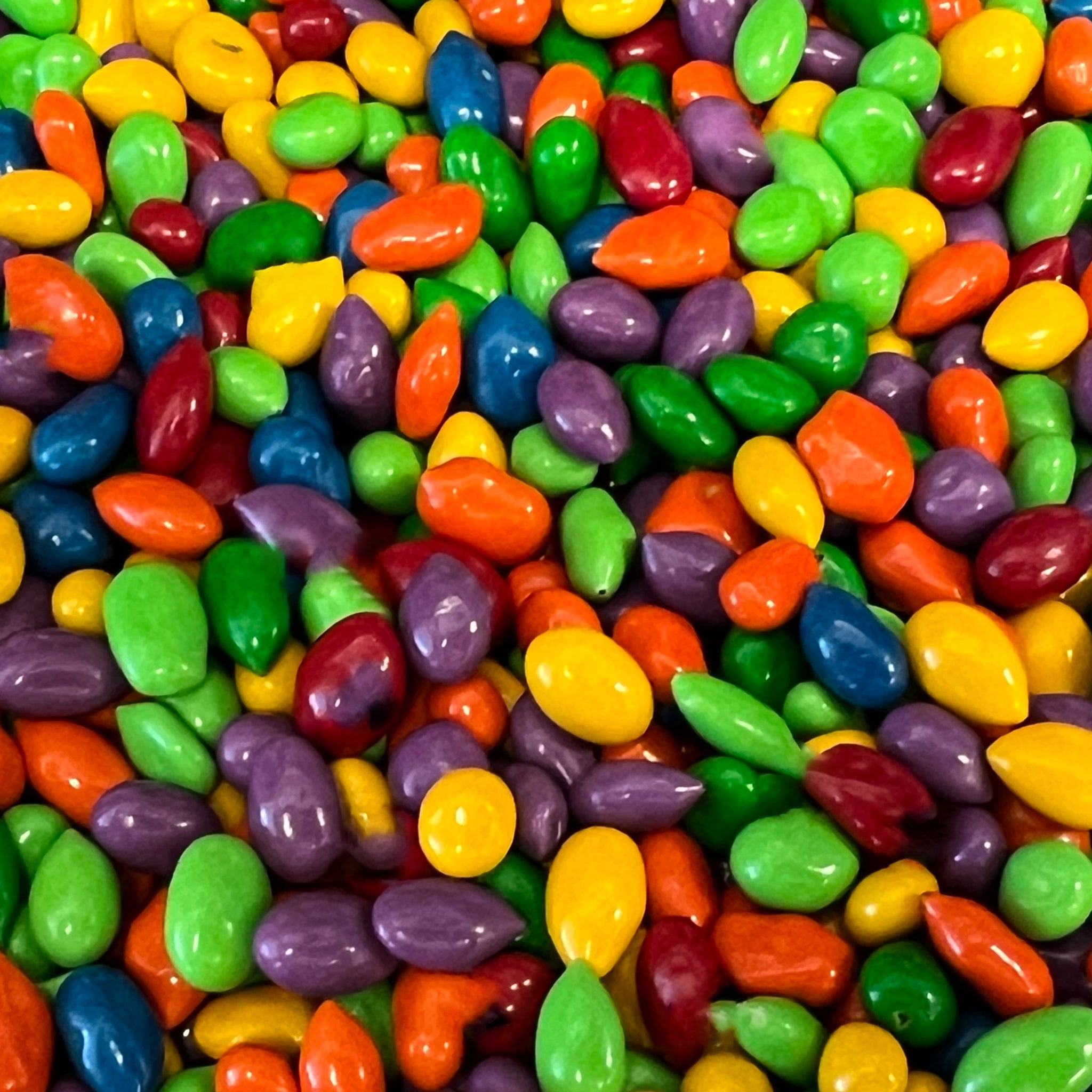 Rainbow colored candy coating over suflower seeds 