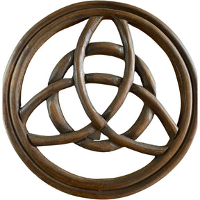 Circular wooden wall hanging with a carved triquetra symbol in the center.