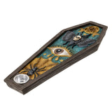 A coffin-shaped gothic decorative tray or planter with a dark wood-grain exterior, featuring a teal and gold inner design with a large eye, bat, spider, pentagram, and small silver bowl.