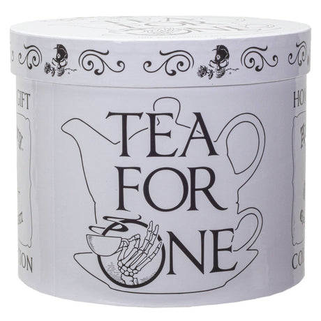 A round white tin canister with a matching lid, featuring black line art of a teapot, a teacup, a skeleton hand holding a teacup, and the words 'TEA FOR ONE' on the front.