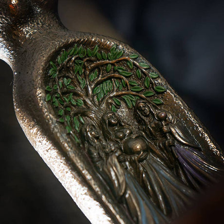 Decorative object with a tree of life and figures design on a dark background