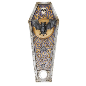 A coffin-shaped wall hanging or decorative plaque featuring a black bat on a gold crescent moon, with a skull and ornate gold scrollwork on a blue-gray background, shown on a plain white background.
