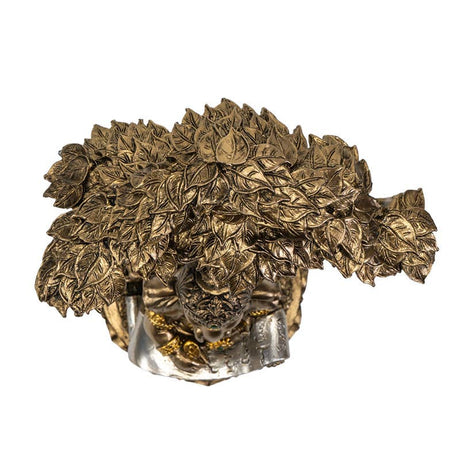 Bronze sculpture of a head with leafy hair on a white background