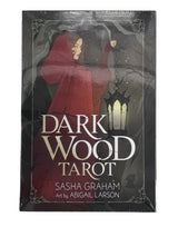 dark wood tarot with black box with image of woman in red cloak 