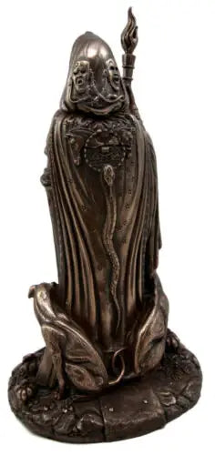 Bronze statue of a figure in robes with a staff on a white background