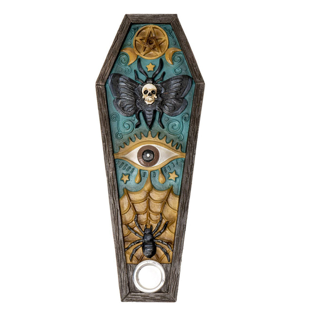 Decorative coffin-shaped doorbell cover with gothic elements on a white background