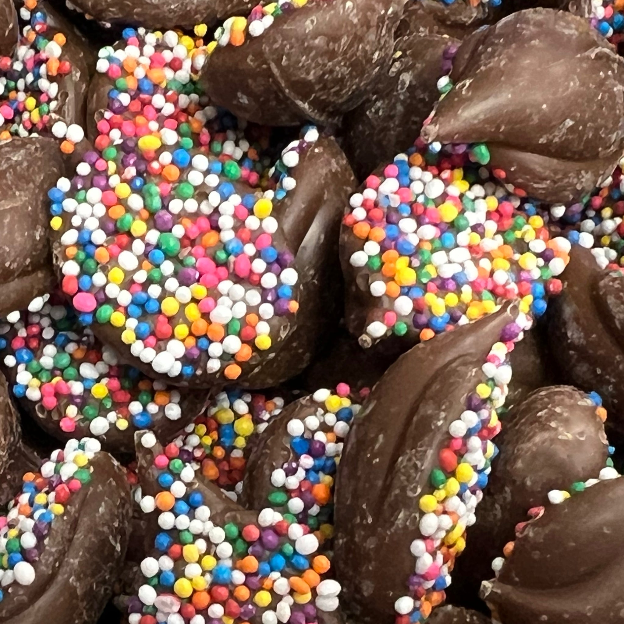 Milk chocolate disks covered with crunchy rainbow sprinkles 