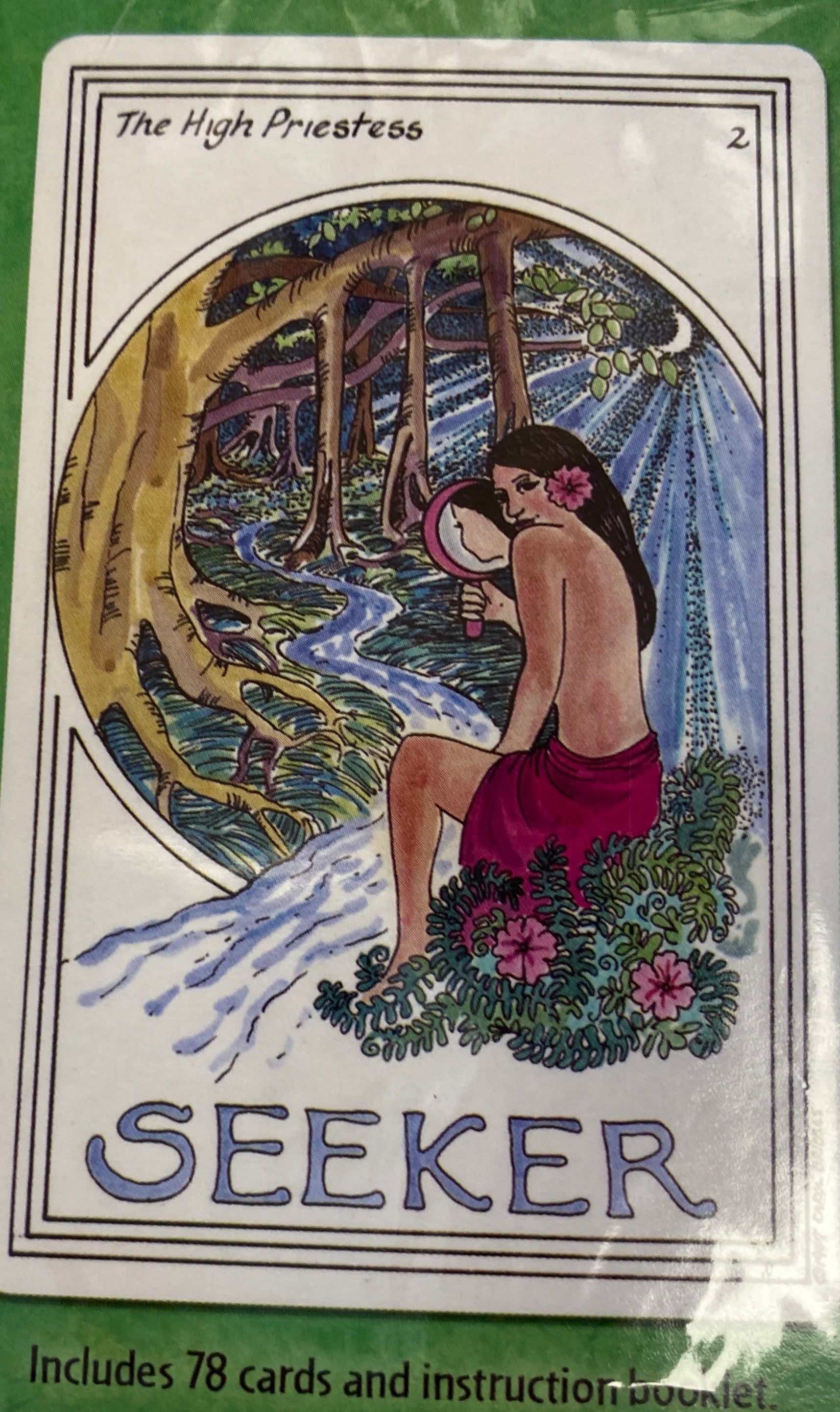 Back of box in gree with image of woman near a stream 