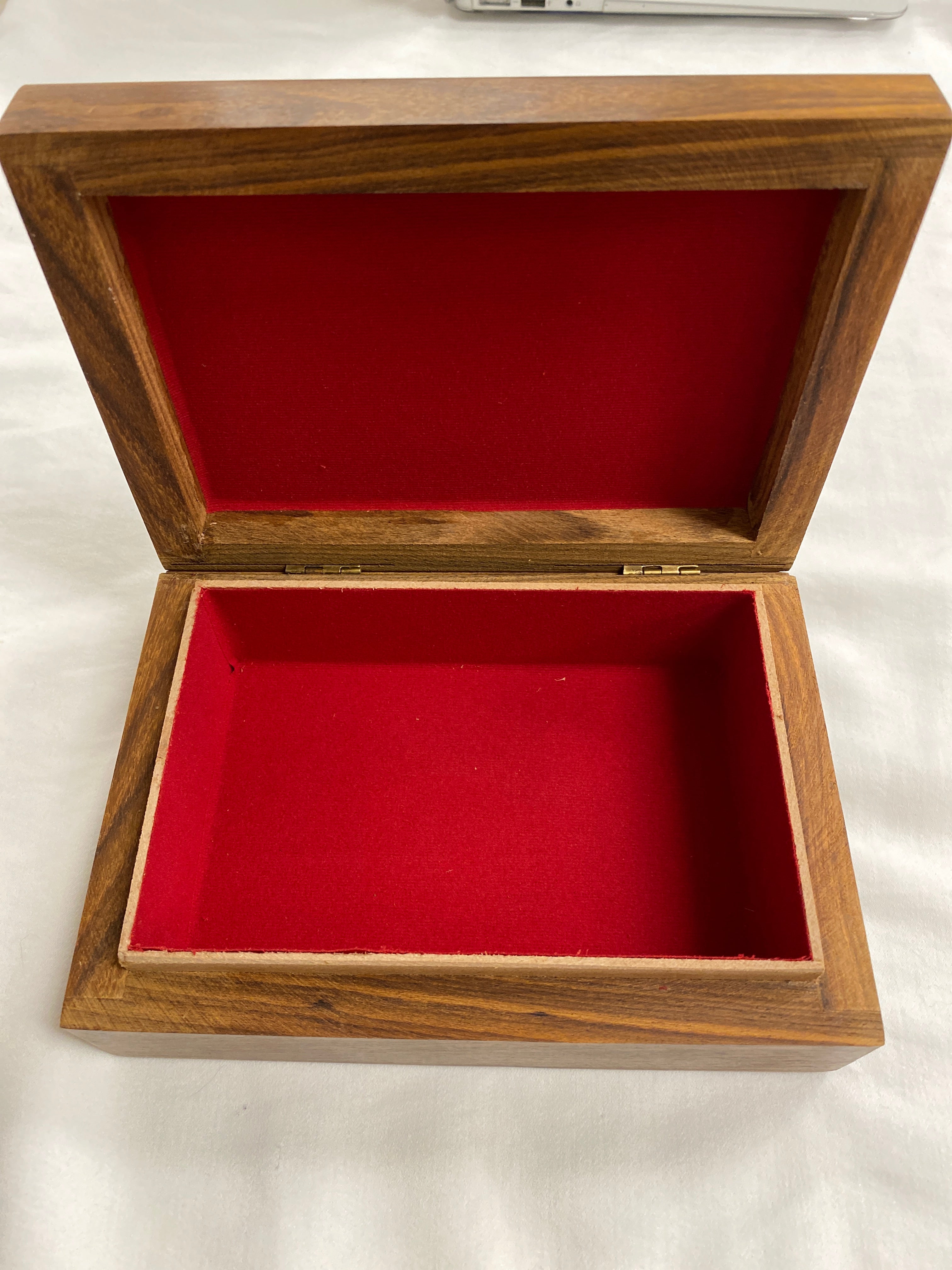 open wood box red cloth on inside 