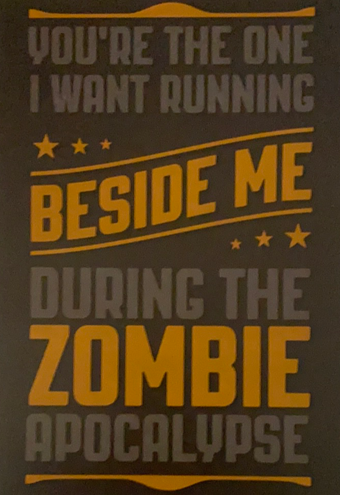 dark brown card with yellow writing about zombies 