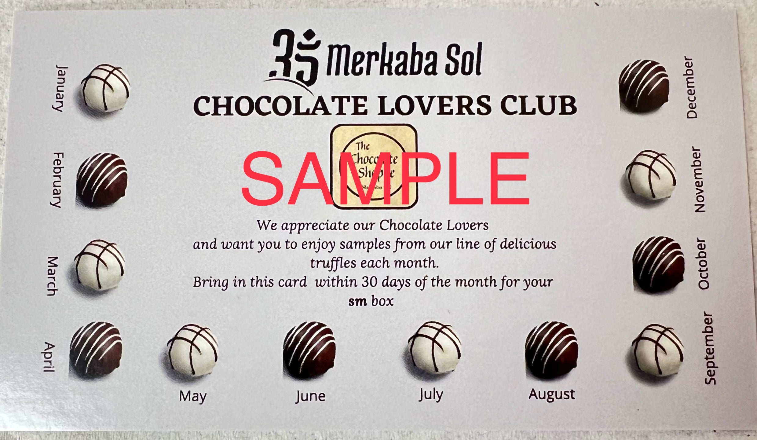 Chocolate Lovers Club Card Small.  This credit card shaped card is dark brown with pictures of white and dark chocolates bordering three edges.  Each picture of a chocolate has one of the months of the year below it.  